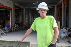 Graduate of HopeWorks internship program, Michael DeRogatis, proudly signed the final beam. (Lizz Giordano / The Herald)