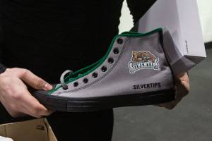 Zack Andrusiak holds a custom made Chuck Taylor shoe, given to players who have scored hat tricks, on Thursday, March 14, 2019 in Everett, Wash. (Andy Bronson / The Herald)