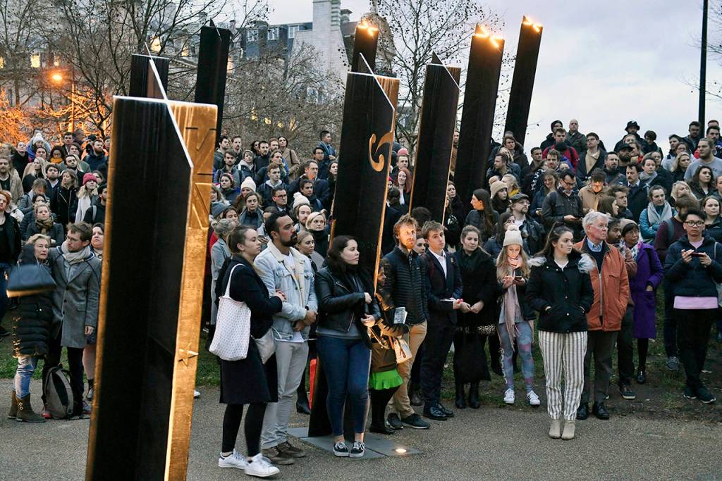 People take part in a vigil at the New Zealand War Memorial on Hyde Park Corner in London on Friday. Other members of Britains royal family have followed Queen Elizabeth II in expressing their sadness over the shootings in Christchurch New Zealand. (Dominic Lipinski/PA via AP)