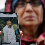 Akhtar Khokhur, 58, shows a picture of her missing husband Mehaboobbhai Khokhar during an interview outside an information center for families Saturday in Christchurch, New Zealand. (AP Photo/Vincent Thian)