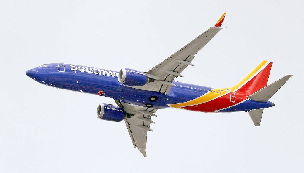 A Southwest Airlines Boeing 737 MAX 8 jet flies over Mesa, Arizona, last week before the model was grounded. (AP Photo/Elaine Thompson)
