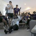 Members of the University of Washington mens basketball team to react to the announcement that they had been selected to play in the NCAA tournament. The players were gathered at head coach Mike Hopkins house. (Kyle Bruce / UW photo)