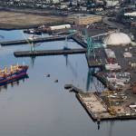 The bulk carrier Jamaica Bay is pushed into the Port of Everett by a pair of tugs near the former Kimberly-Clark mill site in January. (Andy Bronson / The Herald)