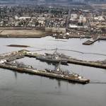 The former Kimberly-Clark mill site is seen from the water, beyond destroyers docked at Naval Station Everett, in January. (Andy Bronson / The Herald)
