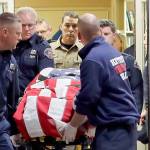 The body of a Kittitas County Sheriffs deputy, draped with a U.S. flag, is carried out of Kittitas Valley Hospital in Ellensburg early Wednesday. The deputy was killed and a police officer was injured after an exchange of gunfire during an attempted traffic stop. (AP Photo/Ted S. Warren)