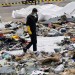 An investigator walks amid debris of Lion Air Flight 610 retrieved from the waters off Tanjung Priok in Jakarta, Indonesia, on Oct. 31, 2018. (AP Photo/Tatan Syuflana, file)
