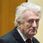Former Bosnian Serb leader Radovan Karadzic enters the court room of the International Residual Mechanism for Criminal Tribunals in The Hague, Netherlands, on Wednesday. (AP Photo/Peter Dejong, Pool)