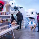 Jedi looks up at his trainer, Penny Potter, as they make their way through the Funko store for a training exercise on March 27 in Everett. (Olivia Vanni / The Herald)