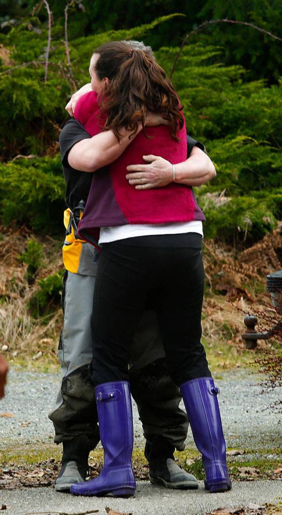 Natasha Huestis gets a hug outside of the Oso Fire Department on March 22, 2014. (Annie Mulligan / For The Herald)