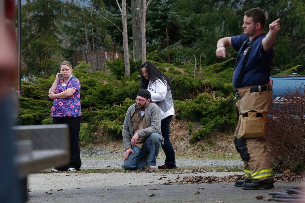 Jonielle Spillers (left) and others gather at the Oso Fire Station on March 22, 2014 to wait for updates about the mudslide. Spillers son Jacob was rescued; her husband and three other children died. (Annie Mulligan / For The Herald)