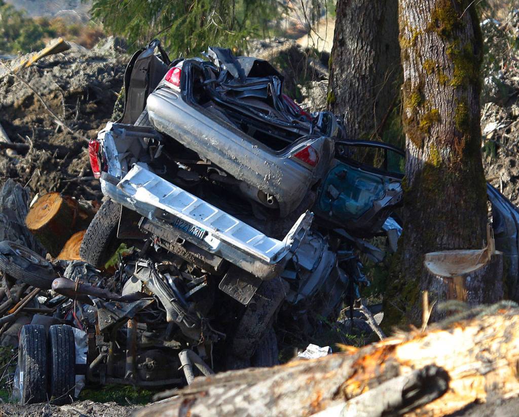 Cars caught in the fatal mudslide are stacked up near the rescue and recovery operations on April 10, 2014. (Genna Martin / The Herald)