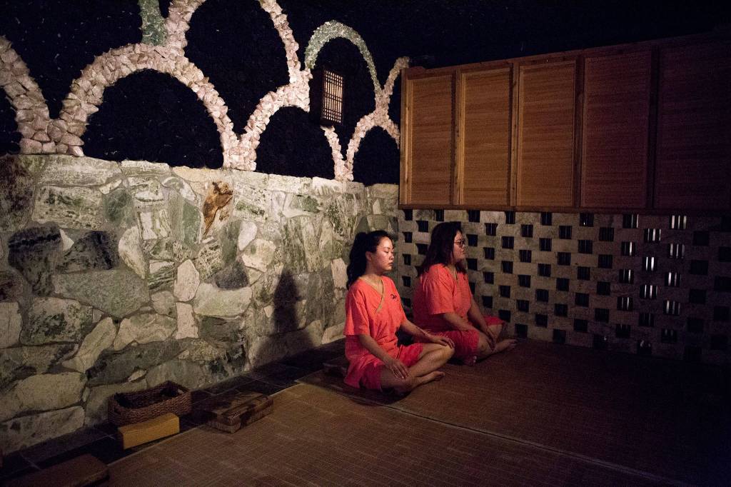 Lilly Shen (left) and Nelly Hwee relax in the charcoal sauna at Q Sauna and Spa in Lynnwood on March 13, 2019. (Olivia Vanni / The Herald)