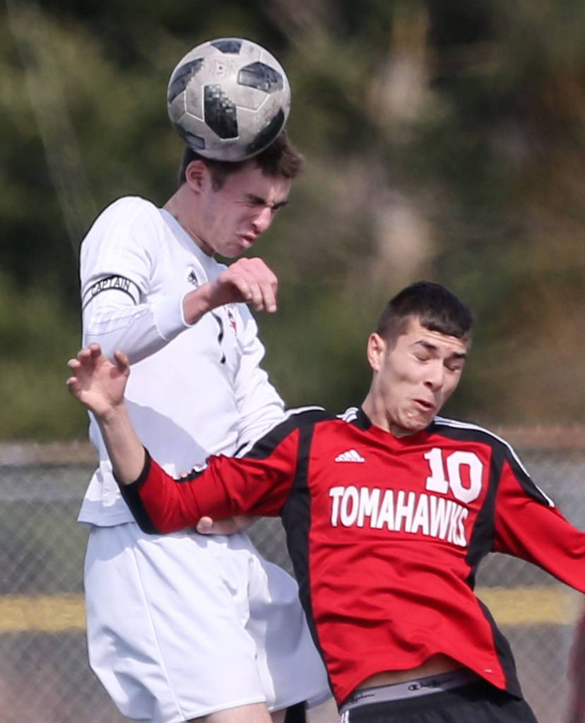 Snohomishs Adam Kowalchyk (left) jumps for a header behind Marysville Pilchucks Kyle Matson. (Kevin Clark / The Herald)