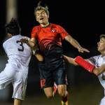 Stanwoods Shintaro Wilcox (center) jumps for a header. (Olivia Vanni / The Herald)