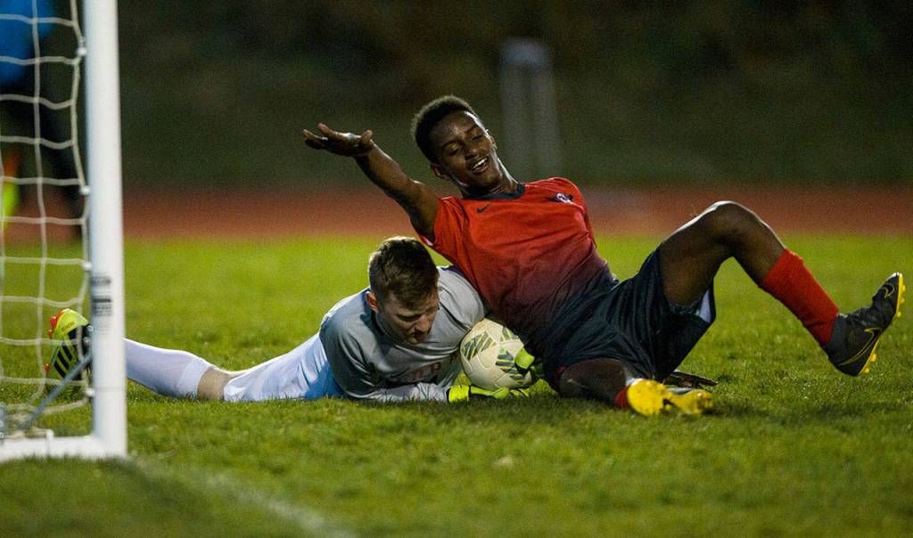 Stanwoods Abdi Maier collides with Mountlake Terraces goalkeeper. (Olivia Vanni / The Herald)