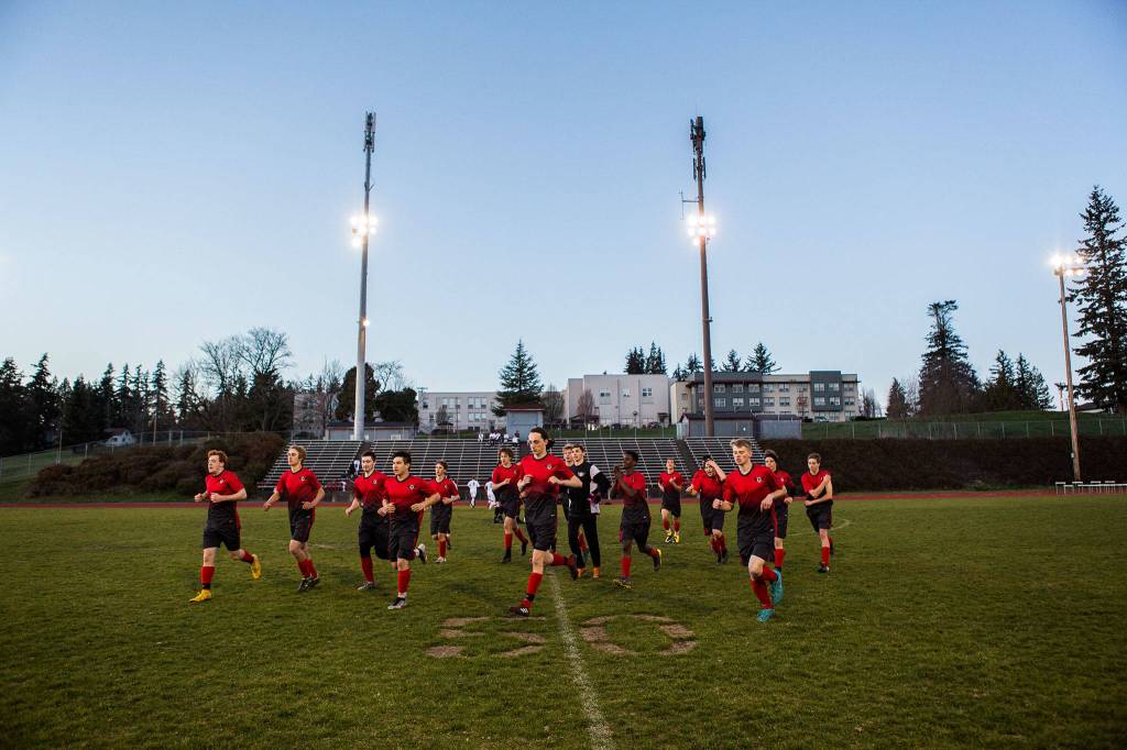 The Spartans jog off the field prior to the final game at Bob Larson Stadium before the grass is replaced by artificial turf. (Olivia Vanni / The Herald)