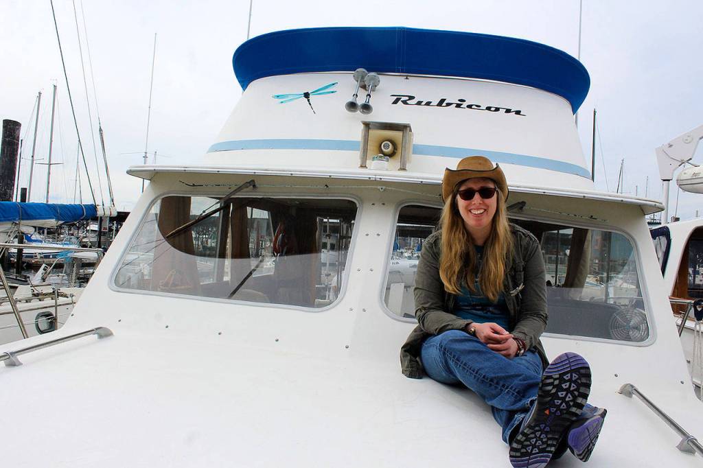 Holly Chadwick aboard her boat, Rubicon, where she lives at Oak Harbor Marina. (Patricia Guthrie / Whidbey News Group)