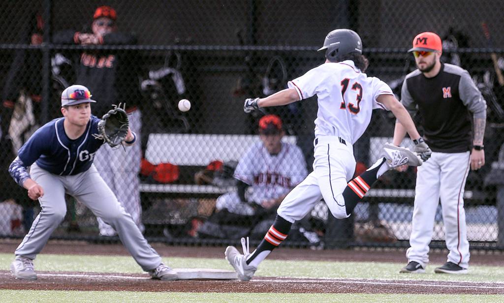 Monroes Nate Cain beats the throw to Glacier Peaks Zack Rodriguez at first base Wednesday afternoon at Monroe High School on March 27, 2019. The Bearcats won 9-1. (Kevin Clark / The Herald)