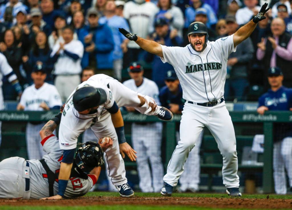 MarinersՠDavid Freitas waves his arms and yells that MarinersՠMitch Haniger is safe during a play at home plate during the game against the Red Sox on Thursday, March 28, 2019 in Seattle, Wash. (Olivia Vanni / The Herald)