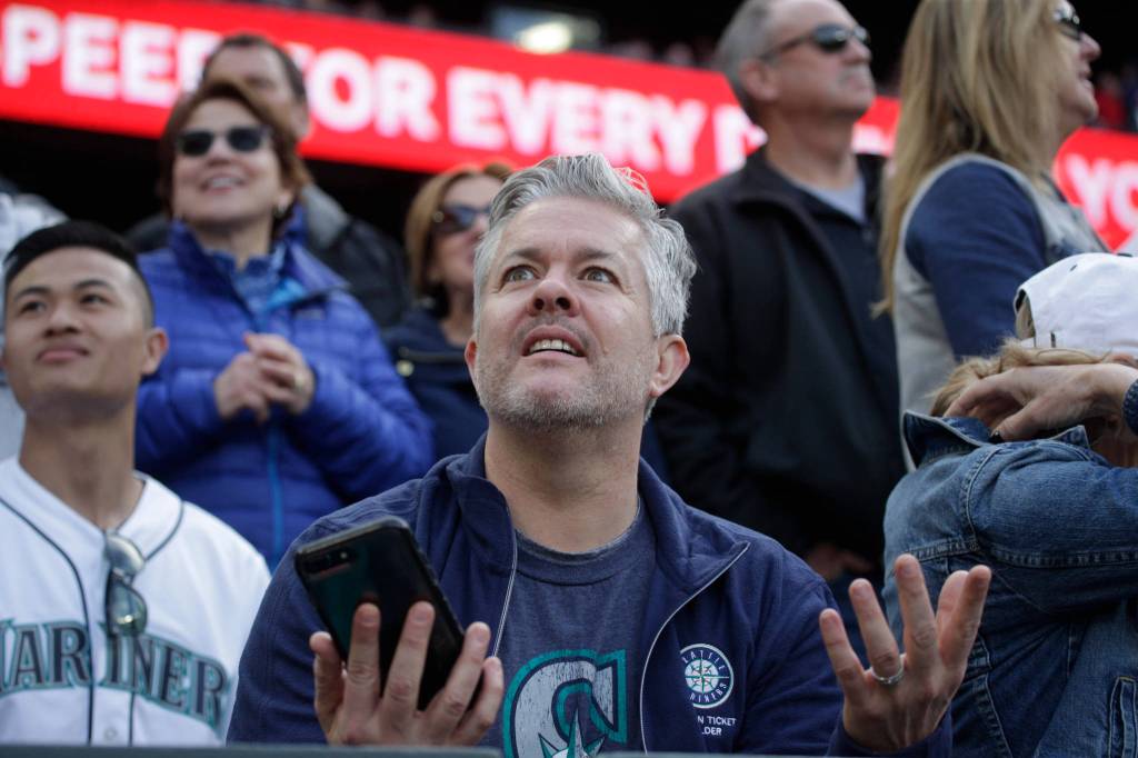 A fan reacts as umpires review a play at home as the Seattle Mariners took on the Boston Red Sox at T-Mobile Park on Thursday, March 28, 2019 in Seattle, Wash. Mitch Haniger was called out on the play. (Andy Bronson / The Herald)