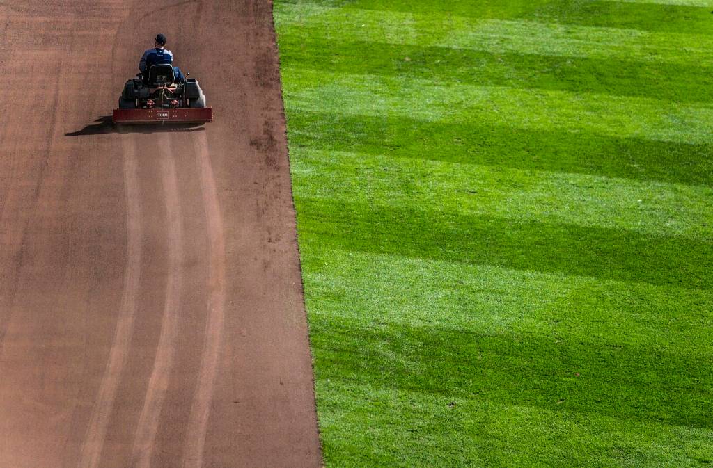 The grounds crew preps the field before the game during Opening Day at T-Mobile Park on Thursday, March 28, 2019 in Seattle, Wash. (Olivia Vanni / The Herald)