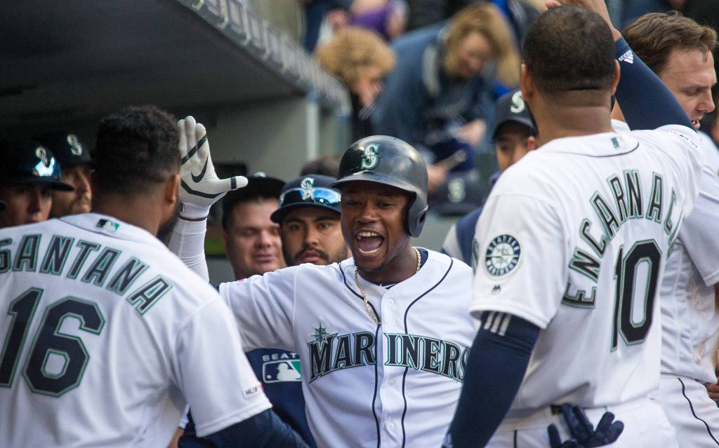 Mariners Tim Beckham celebrates with high fives in the dugout as the Seattle Mariners took on the Boston Red Sox at T-Mobile Park on Thursday, March 28, 2019 in Seattle, Wash. (Andy Bronson / The Herald)