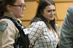 TayLor Smith fights back tears as she is escorted out of the courtroom in handcuffs Wednesday after being sentenced at the Clark County Courthouse in Vancouver, Washington. Smith pleaded guilty to pushing Jordan Holgerson off the bridge at Moulton Falls Regional Park in August. She was sentenced to two days in jail and 38 days on a county work crew. (Amanda Cowan/The Columbian via AP)
