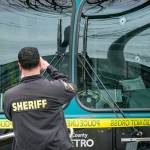Several bullet holes can be seen in the drivers side window of a Metro Bus on Northeast 125th Street, between 32nd and 33rd Avenues Northeast, after a shooting Wednesday in Seattle. (Dean Rutz/The Seattle Times via AP)