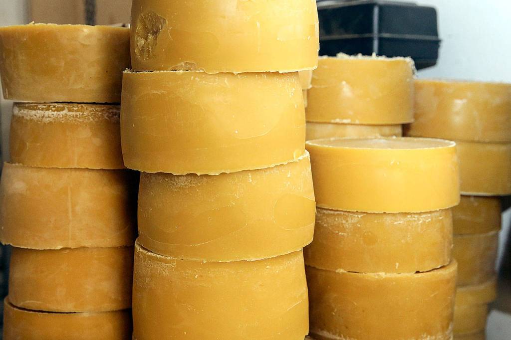 Stacks of beeswax await candle and brick production. (Kevin Clark / The Herald)
