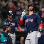 The Red Soxs J.D. Martinez celebrates hitting a solo home run off Mariners starting pitcher Yusei Kikuchi during the sixth inning of a game on March 29, 2019, in Seattle. At left is Mariners catcher Omar Narvaez. (AP Photo/Stephen Brashear)