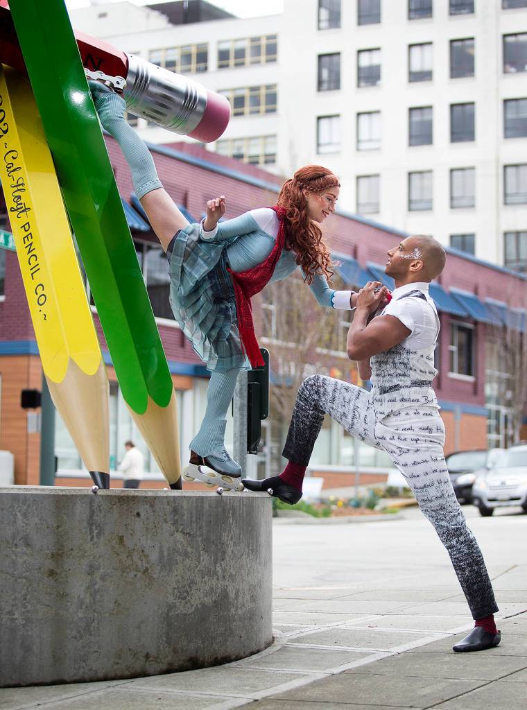 Silja Dos Reis and Jerome Sordillon pose with the statue of No. 2 pencils at the corner of Hoyt Avenue and California Street in Everett. (Andy Bronson / The Herald)