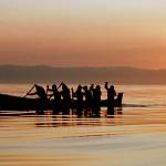 In this 1998 photo, Makah Indians paddle away from the rising sun as they head from Neah Bay toward open Pacific Ocean waters during a practice paddle ahead of its first whale hunt in 70 years. Federal officials are now supporting the Native American tribes decades-long request to resume whale hunts off the coast of Washington state. (AP Photo/Elaine Thompson, File)