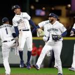 The Mariners Tim Beckham (from left-right), Mallex Smith, Domingo Santana and Mitch Haniger celebrate after the team beat the Angels 2-1 in a game on April 2, 2019, in Seattle. (AP Photo/Elaine Thompson)