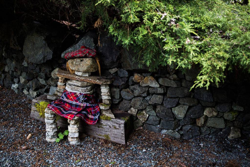 The wall builders made a rock figurine that the homeowners dress in a Scottish outfit, except during Seahawks season. (Olivia Vanni / The Herald)