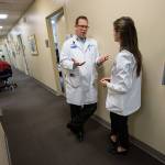 After finishing an ultrasound, Dr. Jimmy Grierson discusses a patients history and follow-up care with second-year WSU med student Charlotte Cronenweth at Providence Marysville on Monday. (Andy Bronson / The Herald)