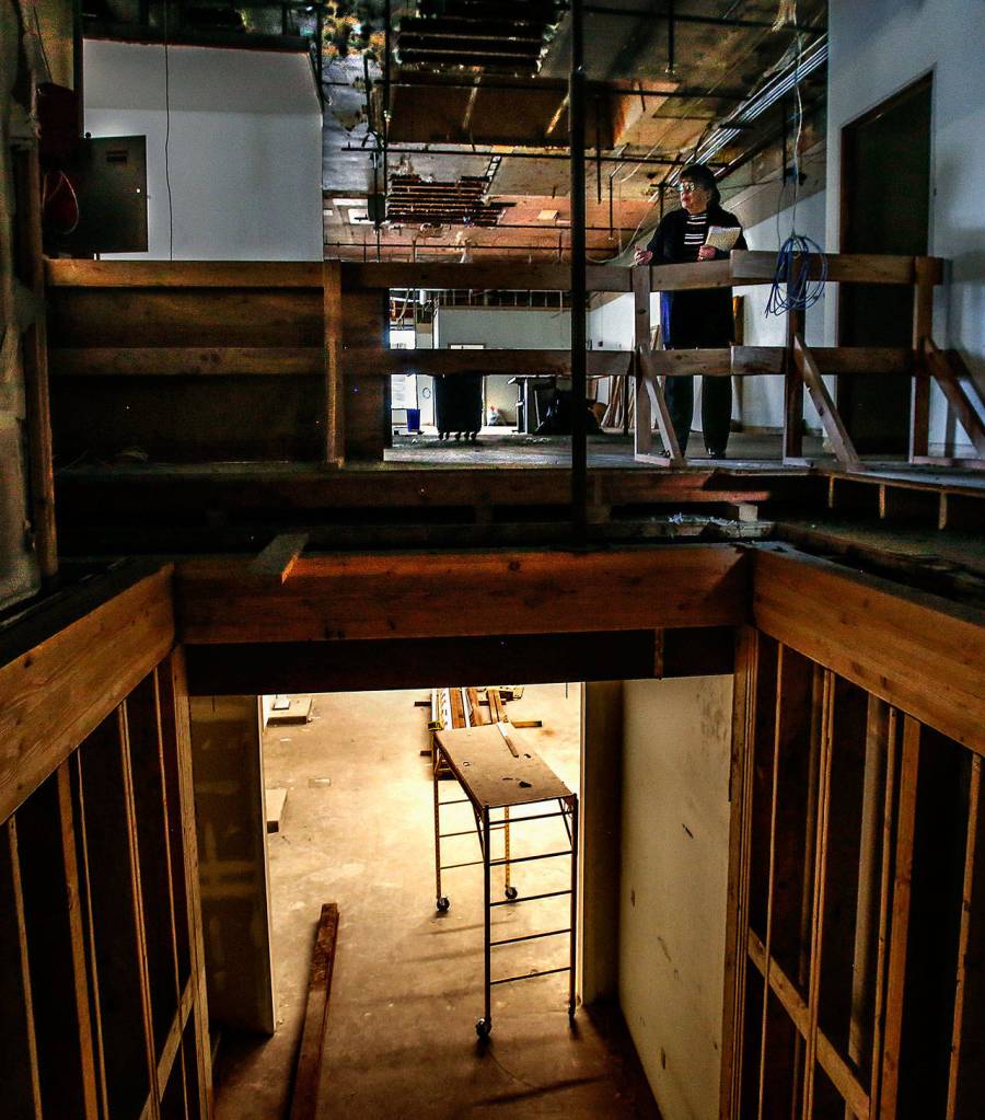 Everett Museum of History Executive Director Barbara George pauses near the top of an elevator shaft while looking around the museums Colby Avenue building. (Dan Bates / The Herald)