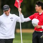 Kamiaks Alvin Kwak (left) shares a laugh with Riley Lai of St. Georges (British Columbia) while replacing the flag on the 18th hole. Kwak and Lai were the tournaments top two finishers. (Kevin Clark / The Herald)