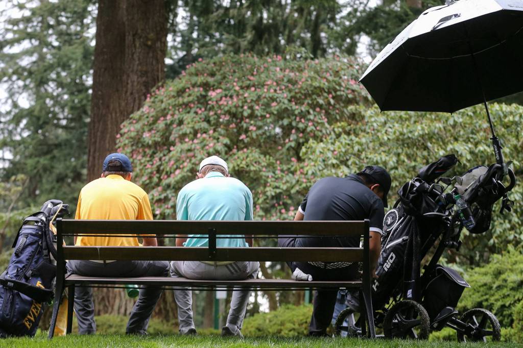 Everetts Austin Duffy (left-right) Glacier Peaks Tyler Spalti and Kamiaks Devin Kim wait to tee off during the Tom Dolan Memorial Invitational golf tournament Monday afternoon at Everett Golf & County Club in Everett on April 8, 2019. (Kevin Clark / The Herald)