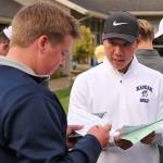Everetts Andrew Martin (left) and Kamiaks Alvin Kwak work to total their scores during the Tom Dolan Memorial Invitational golf tournament Monday afternoon at Everett Golf & County Club in Everett on April 8, 2019. (Kevin Clark / The Herald)