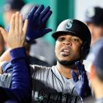 Seattles Edwin Encarnacion is congratulated by teammates after his solo home run during the sixth inning of a baseball game against the Kansas City Royals at Kauffman Stadium in Kansas City, Missouri on Monday. It was the first of two home runs in the inning for Encarnacion. (AP Photo/Orlin Wagner)
