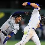 Royals second baseman Chris Owings (right) throws to first base as the Mariners Mallex Smith looks on during the fourth inning of a game on April 10, 2019, at Kauffman Stadium in Kansas City, Mo. (AP Photo/Orlin Wagner)