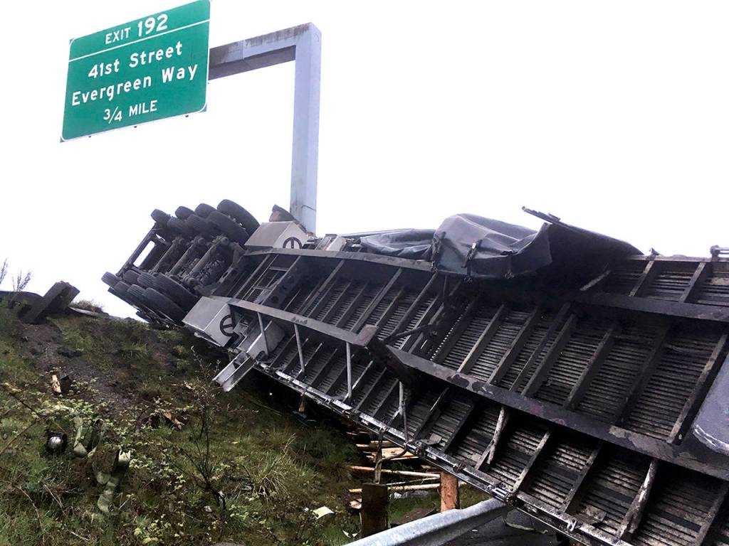 A truck lost a load of lumber after overturning on southbound I-5 near Pacific St. in Everett on Friday morning. (Sue Misao / The Herald)