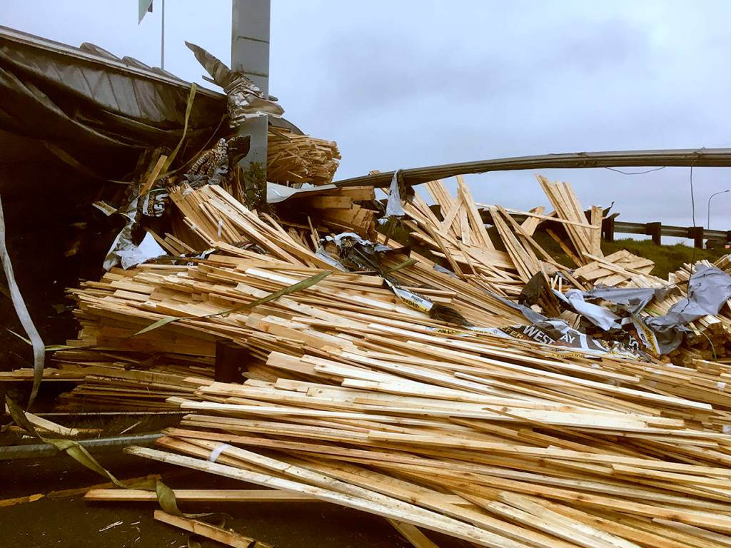 A truck lost a load of lumber after overturning on southbound I-5 near Pacific St. in Everett on Friday morning. (Sue Misao / The Herald)