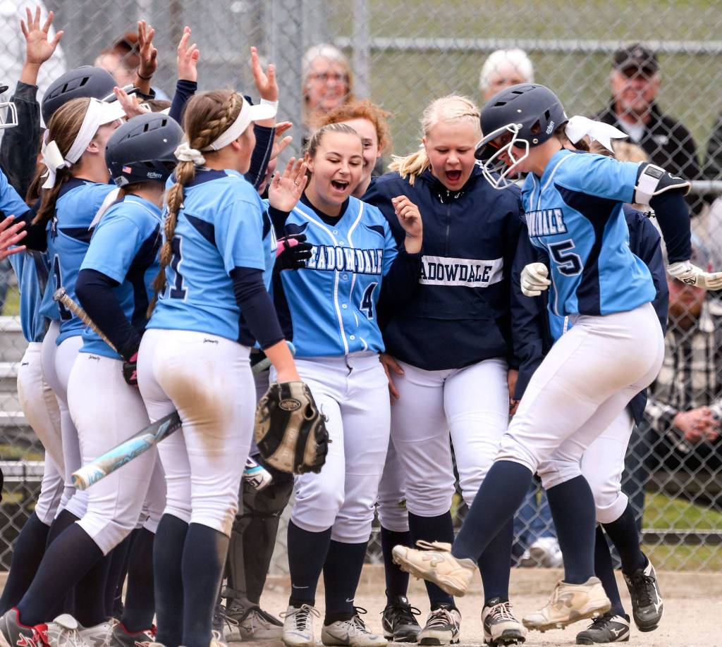 Meadowdales Kelci Studioso (far right) is cheered by her teammates after a homerun single in the second inning against Marysville Pilchuck at Meadowdale High School in Lynnwood on April 2. The Mavericks won 11-1 in 5 innings. (Kevin Clark / The Herald)