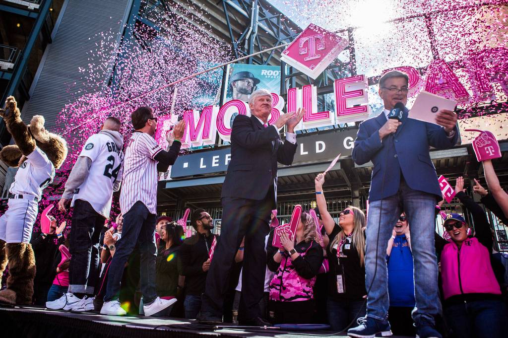 Mariners Chairman John Stanton (center) claps as the confetti canons go off during the T-Mobile Park Gate Opening Ceremony on March 28 in Seattle. (Olivia Vanni / The Herald)