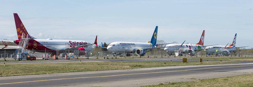 Four out of five 737 Max planes are seen sitting on the crosswind runway at Paine Field on April 4 in Everett. (Andy Bronson / The Herald)
