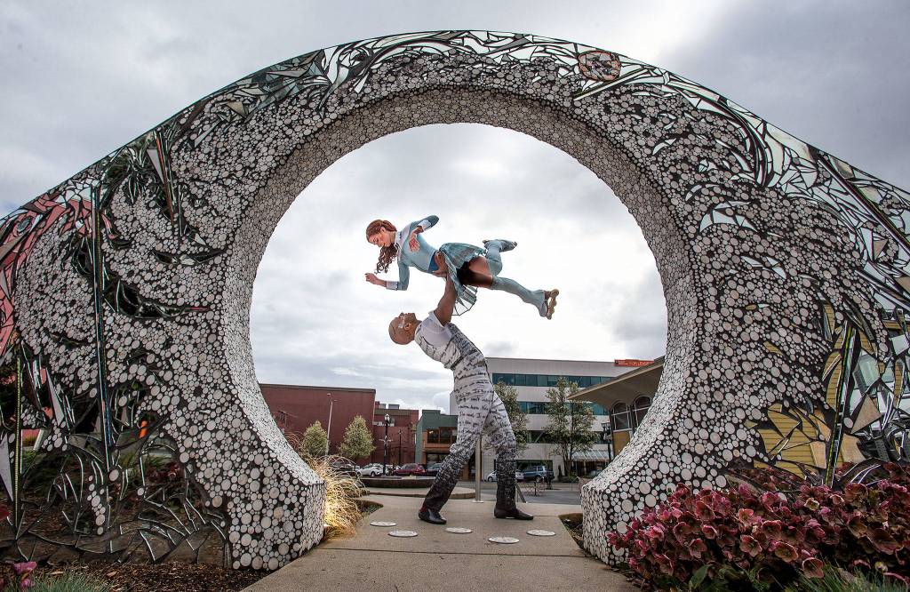 Cirque du Soleil performers Silja Dos Reis, who plays the role of Crystal, and Jerome Sordillon, who plays the role of the love interest, pose at The Convergence Zone sculpture in Stardust plaza at the Wetmore Theater on April 9 in Everett. (Andy Bronson / The Herald)