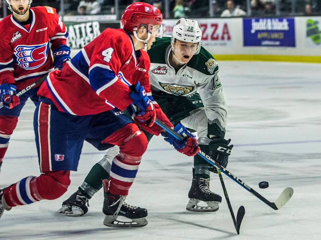 Silvertips Max Patterson fights for the puck against the Spokane Chiefs on April 7 in Everett. (Olivia Vanni / The Herald)