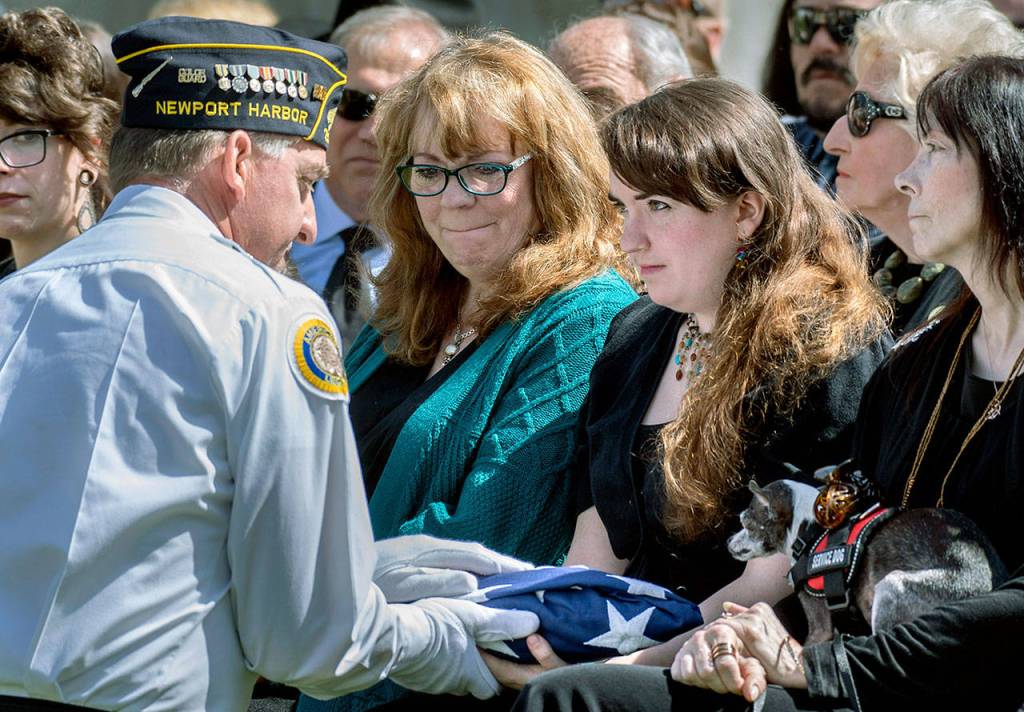 The granddaughter of Edward Nixon, Jilly Matheny, is presented the flag during a memorial service in Yorba Linda, California, on Sunday. (Mindy Schauer/The Orange County Register via AP)