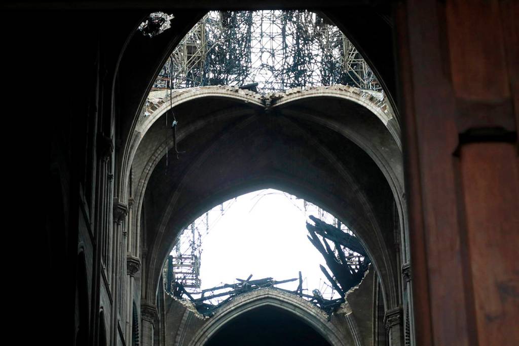 A hole is seen in the dome inside Notre cathedral in Paris on Tuesday. Firefighters declared success Tuesday in a more than 12-hour battle to extinguish an inferno engulfing Paris iconic Notre Dame cathedral that claimed its spire and roof, but spared its bell towers and the purported Crown of Christ. (Christophe Petit Tesson, Pool via AP)
